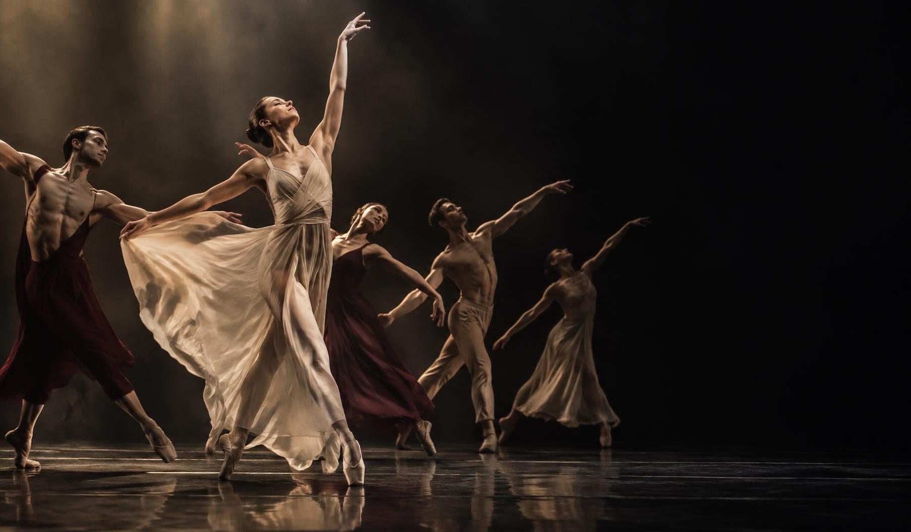 Illustrative ballet ensemble performing an expressive contemporary work on stage