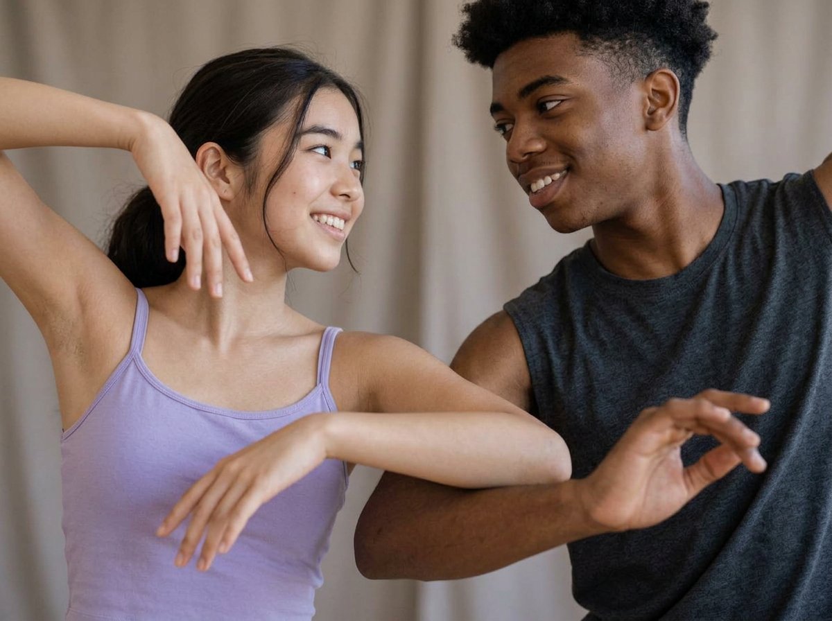 Illustrative close-up of teenage dancers sharing expressive movement against a softly blurred neutral background